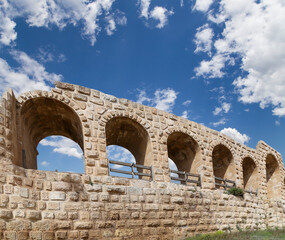 Roman ruins (against the background of a beautiful sky with clouds) in the Jordanian city of Jerash (Gerasa of Antiquity), capital and largest city of Jerash Governorate, Jordan