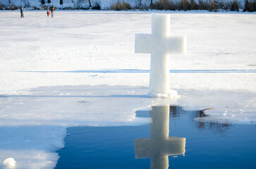 Orthodox Ice Cross on Frozen Lake Reflecting in Water During Epiphany Celebration