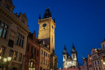 Fototapeta premium Iconic Astronomical Clock Tower on Old Town Square in Prague at night, Czechia, Central Europe. Illuminated church of Our Lady before Tyn. Overall impression is one of magic and mystery. Tourism