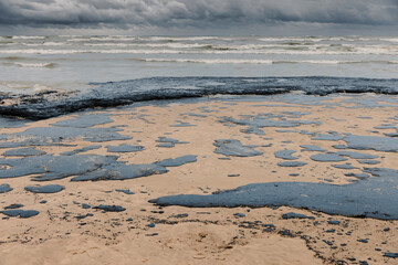 Oil in coastline after a tanker wreck. Fuel oil polluted beach