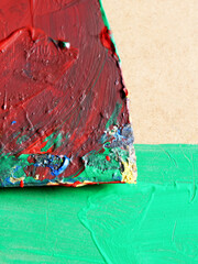 Painter's old dirty spatula on green background
