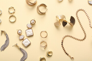 Different beautiful jewelry on yellow background