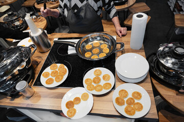 Frying mini pancake cereal in a nonstick frying pan.