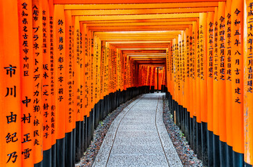The torii gate covered walking path at Fushimi Inari Taisha temple in Kyoto, Japan. ( Japanese...