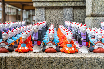 Many fox figurines and statues at Fushimi Inari Shrine, Kyoto Japan. ( Translation of the text from...