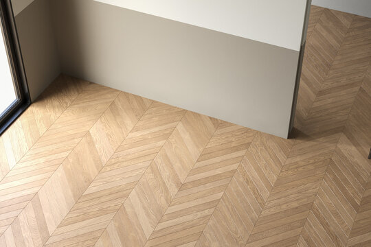 Empty room with modern chevron wood flooring, natural light, and neutral tones for a minimalistic interior concept.