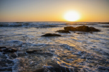 Blurred ocean waves at sunset