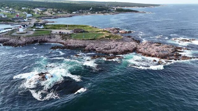 Landscape aerial view of a seaside town with a lighthouse and cliffs in Cape Breton, Nova Scotia