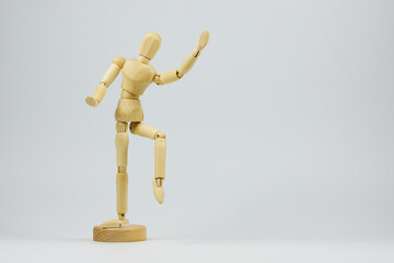 Wooden figure representing various dance movements demonstrating joy and ease