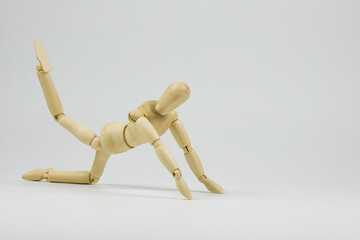 Articulated wooden figure representing the position of some type of physical exercise