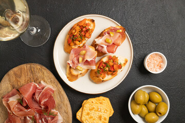 Tasty bruschetta served with wine on gray background. High quality photo