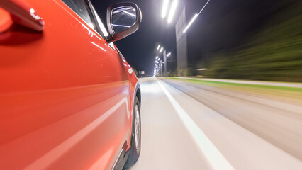Fototapeta premium Drivelapse from Side of Car moving on a night highway timelapse hyperlapse