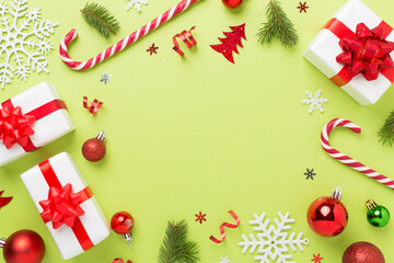 Christmas decor, gift boxes and confetti on color background, top view. Copy space for design