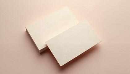 Blank business cards stacked on a subtle pastel background for branding and design presentation