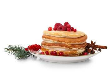 Plate of sweet pancakes with raspberries, red currants and Christmas tree branch on white background
