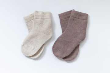 two Pair of striped woolen knitted socks isolated on white