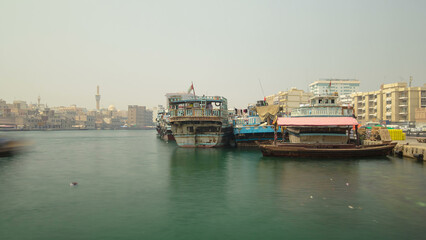 Boats at Port Saeed along Deira's shore of Dubai Creek, UAE. Timelapse