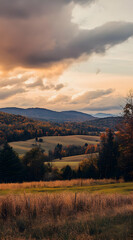 Obraz premium A serene landscape at sunset, showcasing rolling hills and colorful autumn foliage.