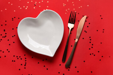 Beautiful table setting with confetti on red background. Valentine's Day celebration