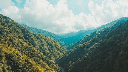 Naklejka premium A serene mountain landscape with lush greenery and winding roads.