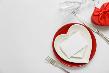 Beautiful table setting with blank card and gift box on grey background. Valentine's Day celebration