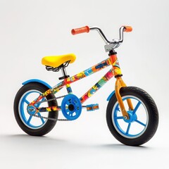 Fototapeta premium A colorful children's bicycle with training wheels and a playful design on a white background 