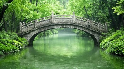 Fototapeta premium A serene stone bridge over a tranquil green river surrounded by lush trees.