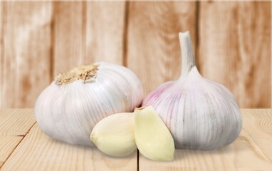 Garlic cloves on wooden table.
