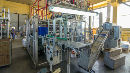 A factory for plastic canister production timelapse hyperlapse. The conveyor in the factory.