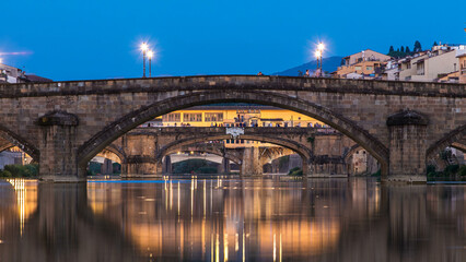 Naklejka premium Ponte Alla Carraia and Santa Trinita Holy Trinity Bridge day to night timelapse over River Arno in Florence