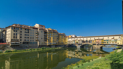 The Ponte Vecchio on a sunny day timelapse hyperlapse, a medieval stone segmental arch bridge over the Arno River, in Florence, Italy