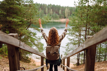 Relaxed woman tourist enjoying nature, breathing fresh air on the lake. Solitude with nature....