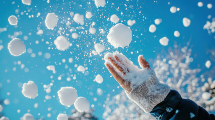 the moment when someone throws artificial snow or snowballs into the air, freezing the moment of their descent.