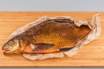 Cold smoked freshwater fish vyrezub on a wooden cutting board