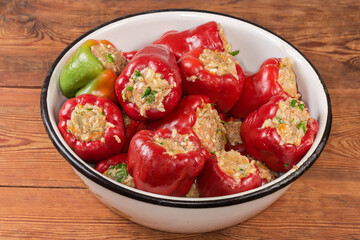 Raw stuffed bell pepper in kitchen bowl on rustic table