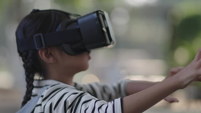 A girl is wearing VR glasses and studying online