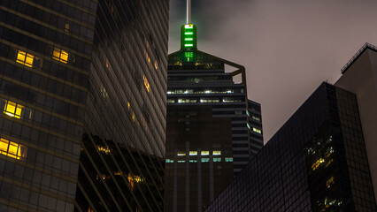 Close up view of the futuristic skyscrapers and their blinking lights as seen at night from below...
