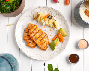 Tender, golden grilled chicken steak  and fresh seasoning. Ideal for healthy, delicious meals , With mashed potatoes, zucchini and carrots