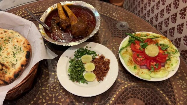 Assortment of delicious naan with mutton nalli nihari at a restaurant in India.