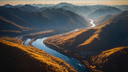 Expansive river winding through golden autumn mountains at sunset
