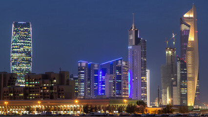 Skyline with Skyscrapers day to night timelapse in Kuwait City downtown illuminated at dusk. Kuwait City, Middle East