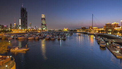 Fototapeta premium Yachts and boats at the Sharq Marina day to night timelapse hyperlapse in Kuwait. Kuwait City, Middle East