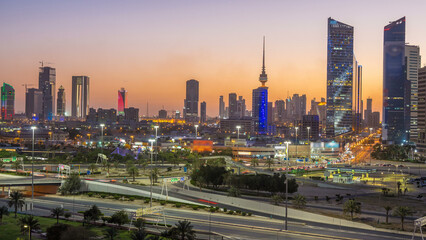 Skyline with Skyscrapers day to night timelapse in Kuwait City downtown illuminated at dusk. Kuwait City, Middle East
