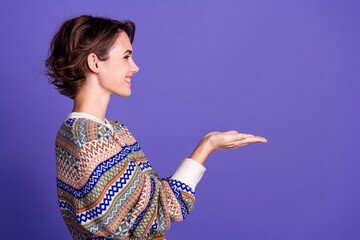 Photo of lovely adorable woman wear stylish clothes demonstrate empty space news isolated on purple...