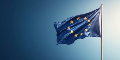 European Union flag waving on flagpole against clear blue sky symbolizing unity and cooperation among member states