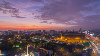 Aerial view of the National stadium in the Peruvian capital Lima with Park of the Reservey day to night timelapse