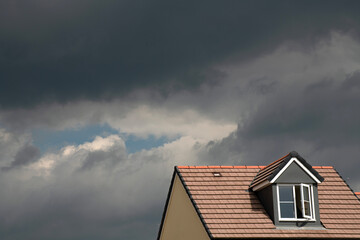 Nimbostratus clouds threatening rain over modern housing.
