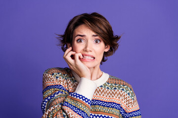 Photo of pretty worried nervous woman wear stylish clothes biting hand isolated on purple color...