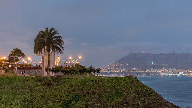 Intihuatana park with panoramic view of Miraflores district and Morro Solar hill on a background day to night timelapse, in Lima, Peru