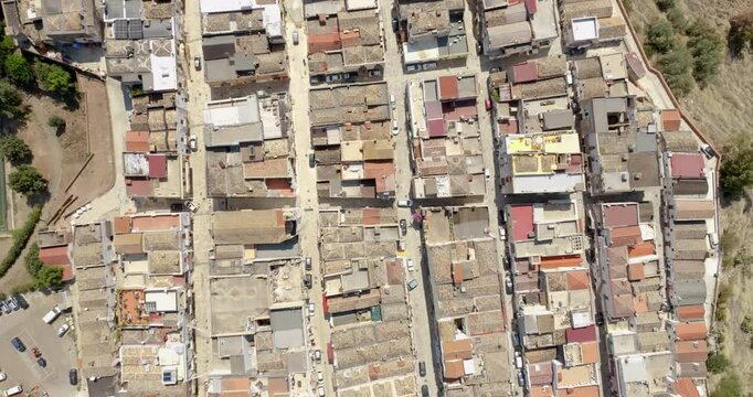 Aerial perpendicular view of houses, apartments and buildings located in the historic center of the town of Bernalda, in the province of Matera, Basilicata, Italy. It is a traditional Italian village.